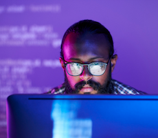 person using a computer in a dark room