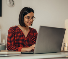 person using a laptop and smiling