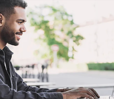 man using a laptop outside