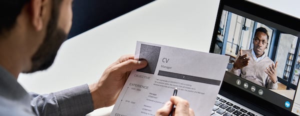 person reviewing a CV in a video interview