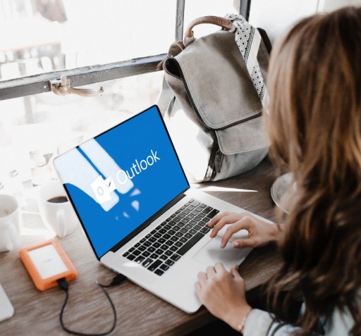 A woman sitting down in front of her desk learning how to bcc in Outlook