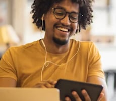 man using a smartphone and smiling