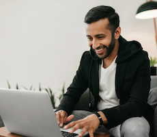 person using a computer and smiling