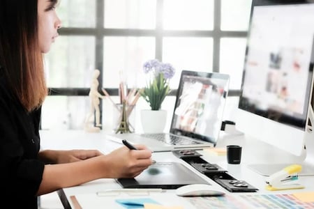 woman at desk using images in marketing