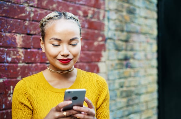 Marketer Using Instagram And Browsing Through Their Feed On A Mobile Phone