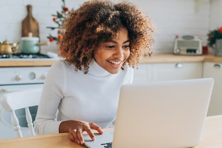 Social media marketer sits in front of computer and gets ideas for instagram bio