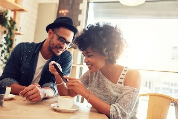 two marketers working on instagram local business page over coffee