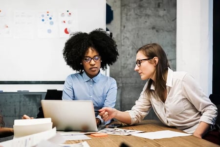 Two women having a discussion about JavaScript scope