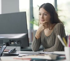 person using a desktop computer in an office