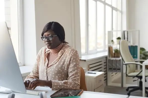 login screens: image shows someone looking at login screens on phone and laptop 