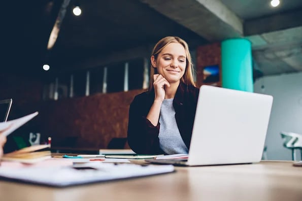 marketer writing long-form content on laptop