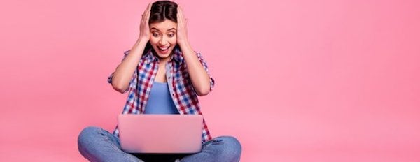 excited person using a laptop