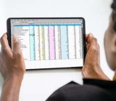 person viewing a spreadsheet on a tablet