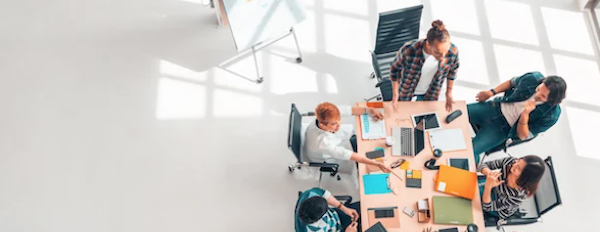 people talking around a conference room table