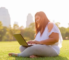 person using a laptop in a park