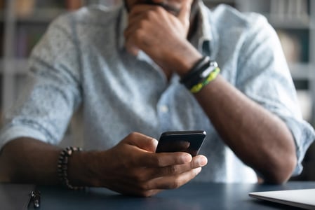 a man watching a video on his smartphone as part of the new digital experience.