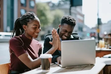 two marketers high-fiving as they successfully onboard new customers