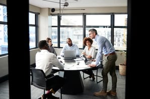 marketing team with an open-door policy collaborates in conference room