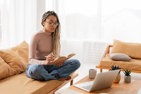 Young woman studying the benefits of open APIs and what they can mean for her organization.