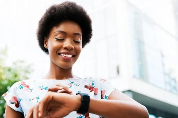 A woman checks her watch to ensure she's being productive.