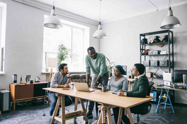 team discusses a project management charter in an office