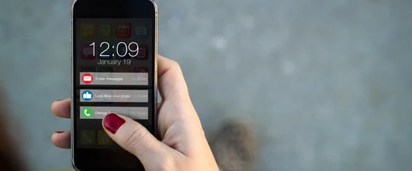 hand on mobile phone getting push notifications