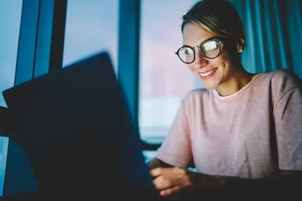 woman using a laptop computer to remove render blocking resources from her wordpress website