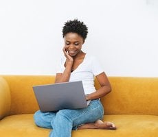 person using a laptop on a couch