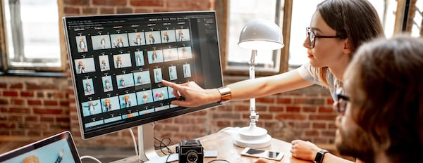 people viewing images on a desktop computer