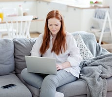 person using a laptop on a couch