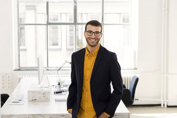 young businessman in his office exploring 40 of the coolest saas website designs