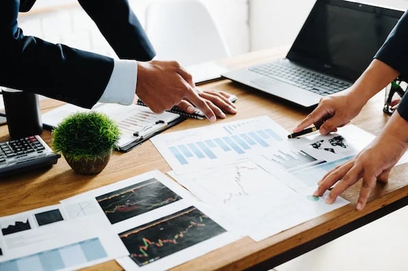 Sales operations manager pointing to printed pages of the ultimate guide to sales operations