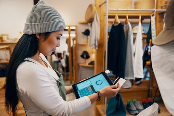 Shop owner using tablet to accept ACH payment