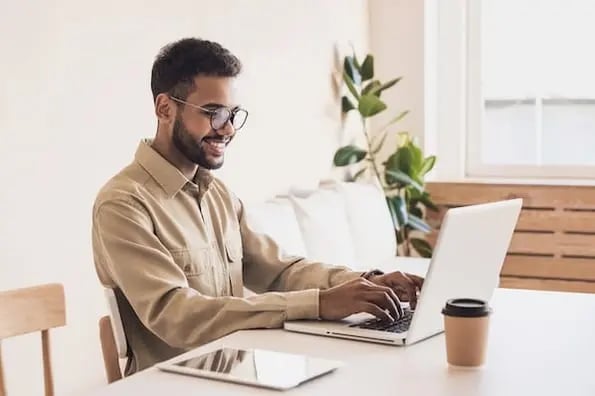 marketer at laptop adding a display of recent posts to your WordPress posts and pages 