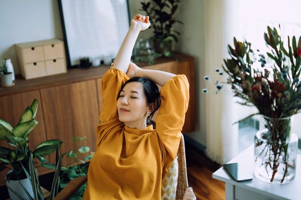 person using a stress management app to meditate in a chair