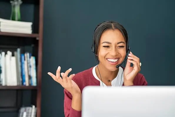 woman on laptop entering information in ticketing system