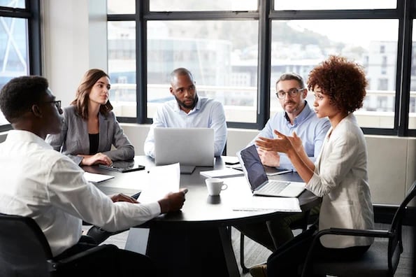 marketers in a meeting discussing upstream and downstream marketing strategies