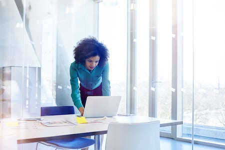 Woman on laptop working within visual studio