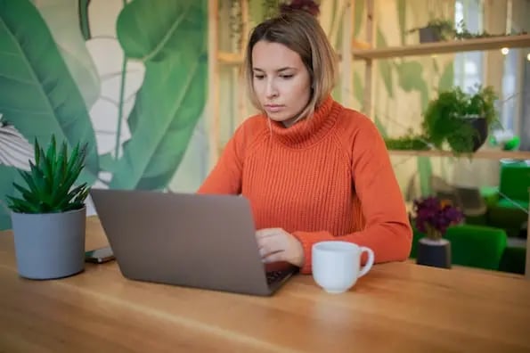 Business owner reading web redesign stats to decide if she should revamp site