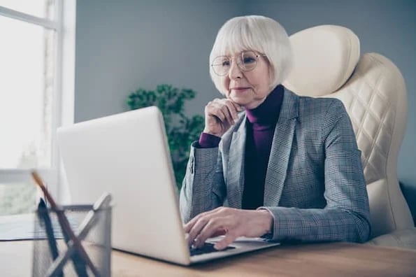 Woman attends a webinar on laptop