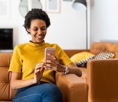 person using a smartphone on a couch