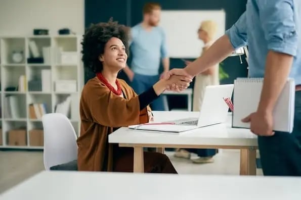 person shaking hands as they start a customer service job