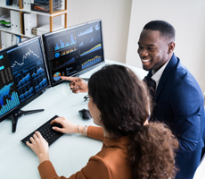 two people reading graphs on a computer