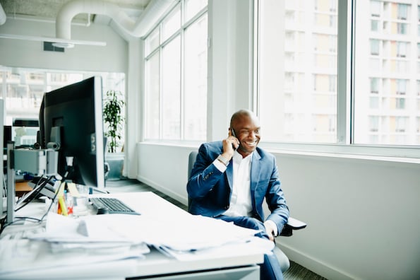 A business development representative talking to a lead on the phone.