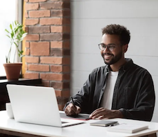 person using a laptop and smiling