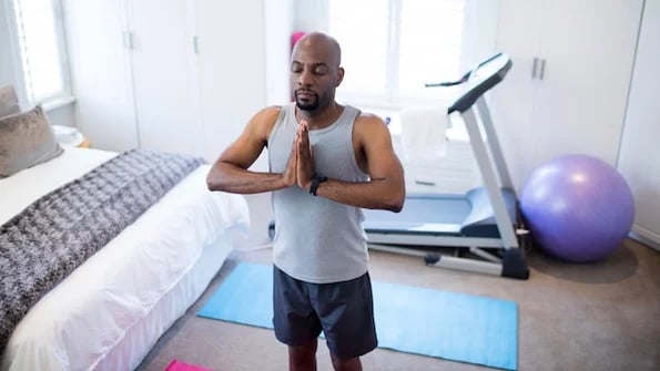 man doing yoga during morning routine