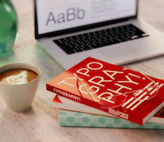 books on a desk with a laptop