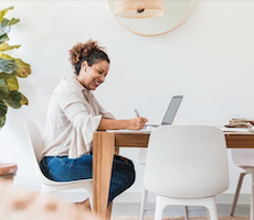 person sitting a table with a laptop