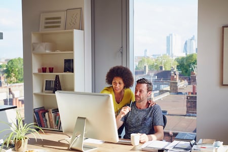 two people browsing wordpress custom post type plugins on a computer in an office