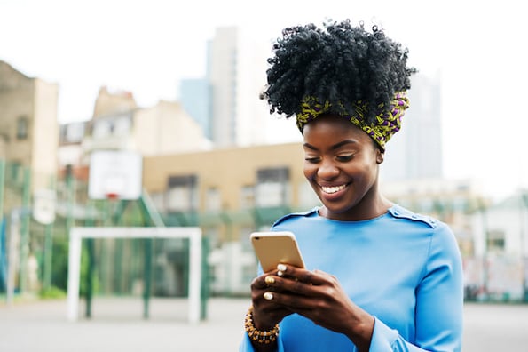 woman using a smartphone to browse a website using a wordpress mobile-friendly plugin